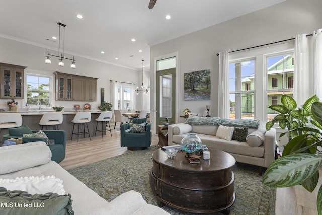 435 Bills Ave, Ocean Springs, MS 39564 - living area featuring light wood-style floors, crown molding, recessed lighting, a ceiling fan, and a chandelier
