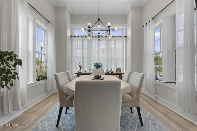 435 Bills Ave, Ocean Springs, MS 39564 - dining area featuring wood finished floors, a chandelier, baseboards, and crown molding
