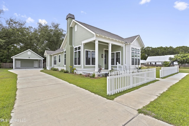 435 Bills Ave, Ocean Springs, MS 39564 - view of front of house featuring a porch, driveway, an outdoor structure, a chimney, and roof with shingles