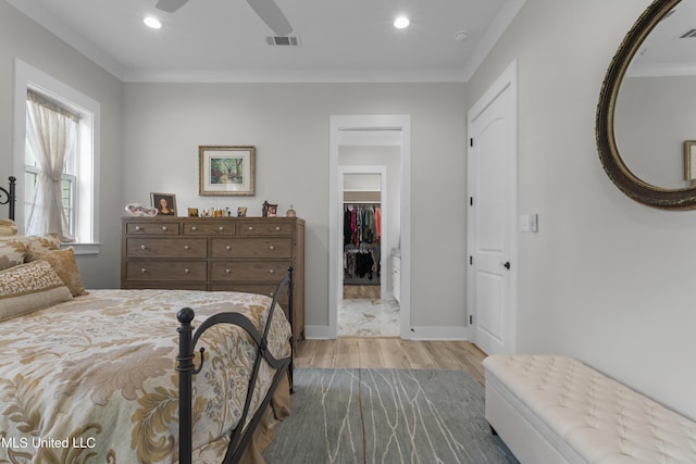 435 Bills Ave, Ocean Springs, MS 39564 - bedroom with wood finished floors, a walk in closet, ornamental molding, baseboards, and recessed lighting