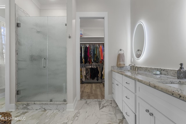 435 Bills Ave, Ocean Springs, MS 39564 - bathroom with a spacious closet, marble finish flooring, a stall shower, double vanity, and baseboards
