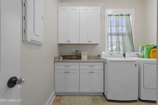 435 Bills Ave, Ocean Springs, MS 39564 - laundry area featuring independent washer and dryer, light wood-style floors, cabinet space, electric panel, and baseboards