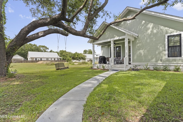 435 Bills Ave, Ocean Springs, MS 39564 - view of front of house featuring covered porch, ceiling fan, and a front lawn
