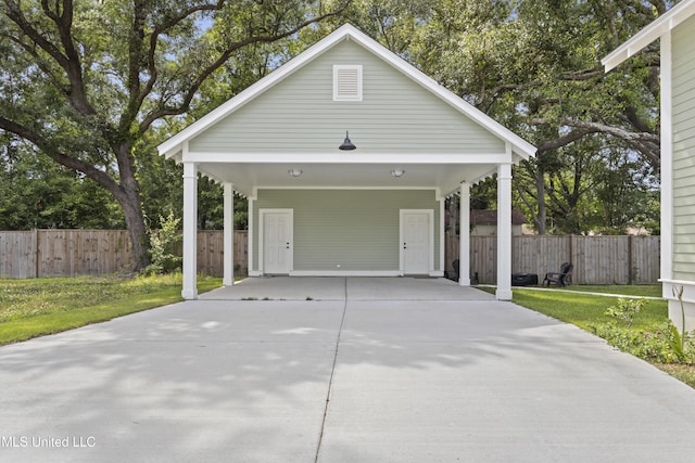 435 Bills Ave, Ocean Springs, MS 39564 - garage with concrete driveway and a carport