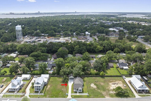 435 Bills Ave, Ocean Springs, MS 39564 - aerial perspective of suburban area with a nearby body of water, a notable bridge, and a tree filled landscape
