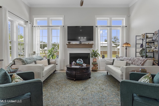 435 Bills Ave, Ocean Springs, MS 39564 - living room with healthy amount of natural light, a fireplace, ornamental molding, wood finished floors, and a ceiling fan