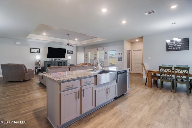 11458 Leann Ct, Ocean Springs, MS 39564 - kitchen featuring stainless steel dishwasher, ceiling fan, a chandelier, light wood finished floors, and a raised ceiling