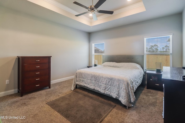 11458 Leann Ct, Ocean Springs, MS 39564 - carpeted bedroom with crown molding, a tray ceiling, multiple windows, a ceiling fan, and baseboards