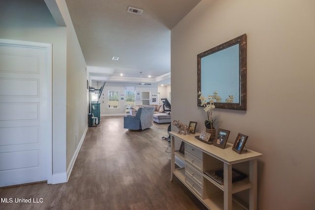 11458 Leann Ct, Ocean Springs, MS 39564 - hallway with dark wood-style floors, a tray ceiling, baseboards, and recessed lighting