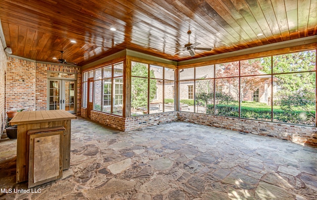 unfurnished sunroom with wood ceiling, french doors, and ceiling fan