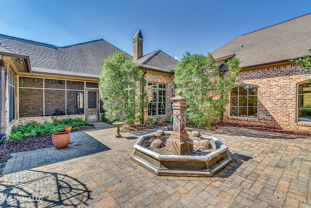 view of patio with a sunroom