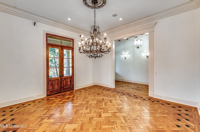 unfurnished dining area featuring ornamental molding, french doors, and light parquet flooring