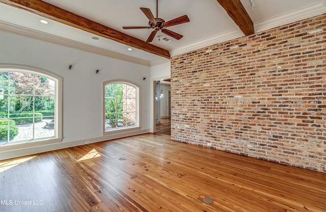 empty room featuring beam ceiling, brick wall, light hardwood / wood-style flooring, and ceiling fan