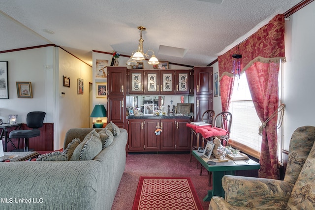 interior space featuring a textured ceiling, vaulted ceiling, ornamental molding, pendant lighting, and dark colored carpet