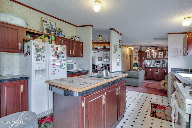 kitchen with a kitchen island, hanging light fixtures, crown molding, a textured ceiling, and white appliances