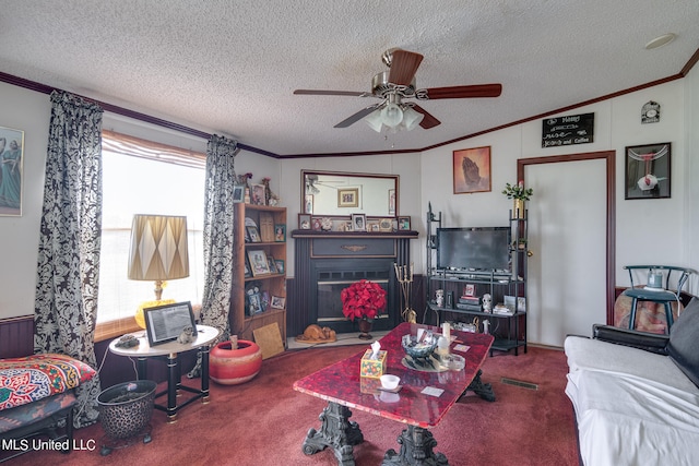 carpeted living room featuring ornamental molding, lofted ceiling, a textured ceiling, and ceiling fan