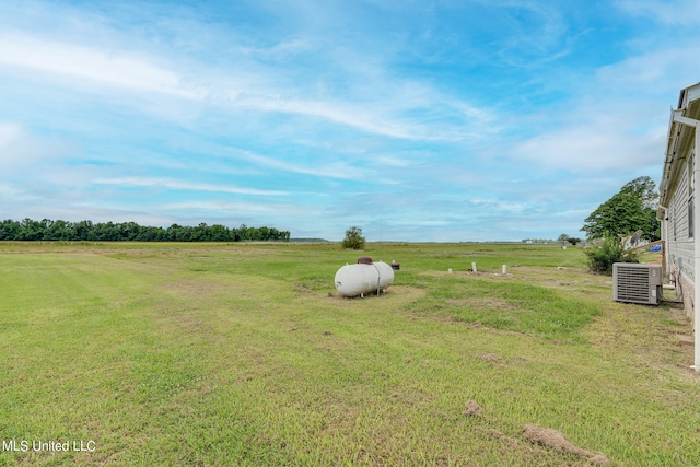 view of yard featuring a rural view and central AC