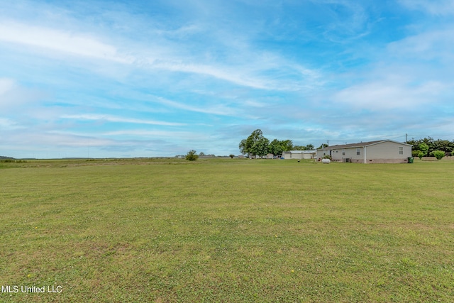view of yard with a rural view