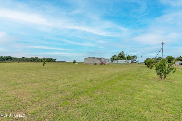 view of yard with a rural view