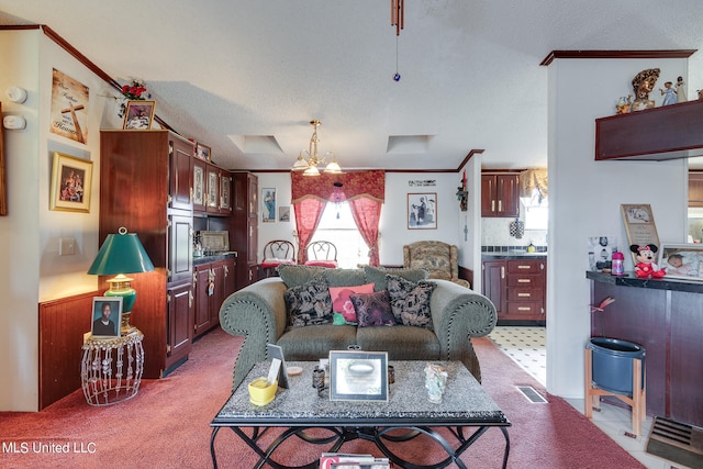 living room with ornamental molding, a textured ceiling, a healthy amount of sunlight, and a skylight