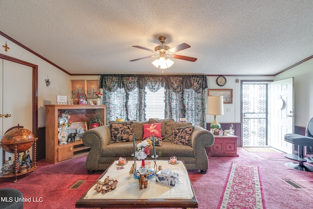 carpeted living room featuring ornamental molding, a textured ceiling, and ceiling fan
