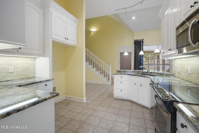 504 Carlisle Cir, Madison, MS 39110 - kitchen featuring stainless steel appliances, a peninsula, and dark stone counters