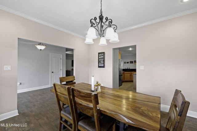 8185 Ridgewood Dr, Kiln, MS 39556 - dining area featuring a chandelier, crown molding, baseboards, and dark wood-style floors