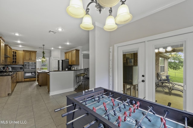 8185 Ridgewood Dr, Kiln, MS 39556 - playroom with light tile patterned flooring, ornamental molding, french doors, and recessed lighting