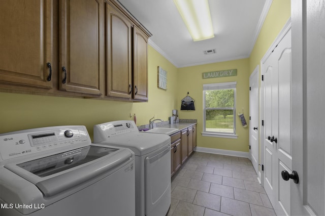 8185 Ridgewood Dr, Kiln, MS 39556 - laundry room with cabinet space, washer and clothes dryer, crown molding, light tile patterned floors, and baseboards