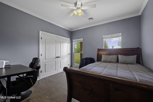 8185 Ridgewood Dr, Kiln, MS 39556 - bedroom featuring dark wood finished floors, crown molding, a closet, a ceiling fan, and an office area