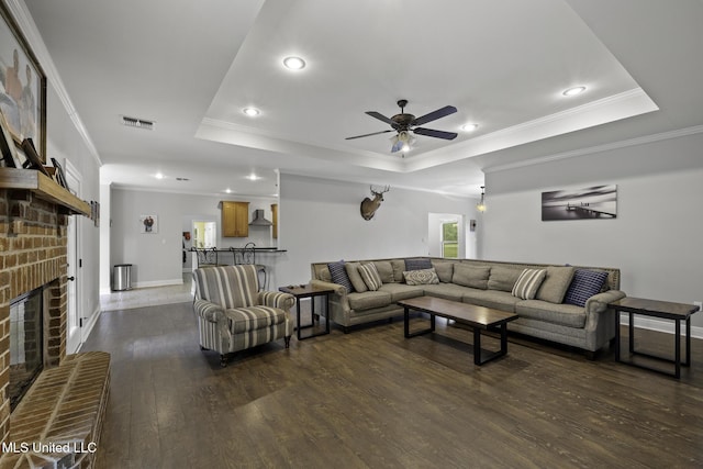 8185 Ridgewood Dr, Kiln, MS 39556 - living area with a tray ceiling, ceiling fan, recessed lighting, dark wood finished floors, and crown molding