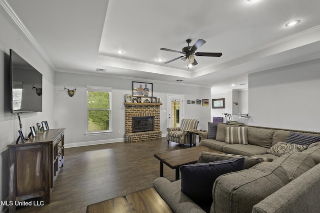 8185 Ridgewood Dr, Kiln, MS 39556 - living area with wood-type flooring, a tray ceiling, ceiling fan, a fireplace, and ornamental molding