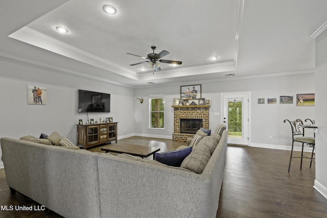 8185 Ridgewood Dr, Kiln, MS 39556 - living area featuring a raised ceiling, recessed lighting, a ceiling fan, a fireplace, and ornamental molding