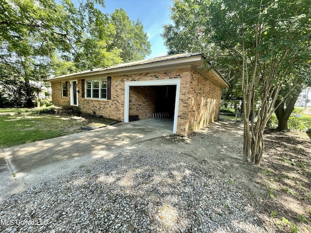1103 N Yale St, Cleveland, MS 38732 - view of property exterior with concrete driveway, an attached garage, and brick siding