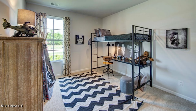 bedroom featuring light colored carpet