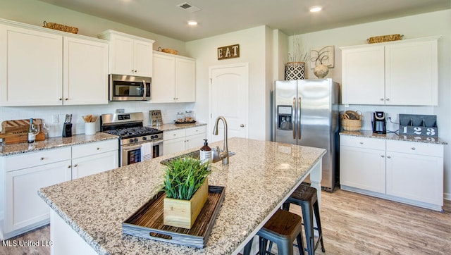 kitchen with white cabinetry and appliances with stainless steel finishes