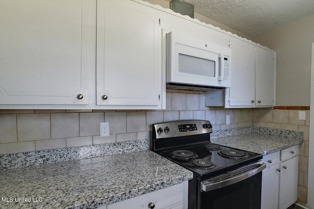 kitchen with light stone countertops, black electric range oven, white cabinets, and a textured ceiling