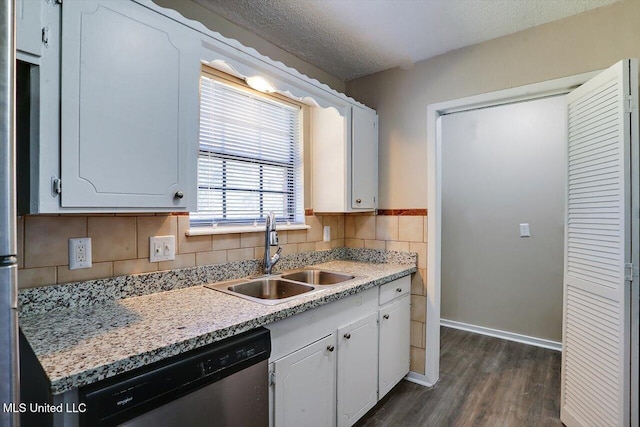 kitchen featuring dark hardwood / wood-style floors, sink, white cabinets, stainless steel dishwasher, and a textured ceiling