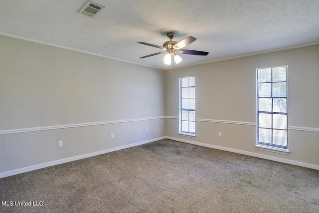 carpeted empty room with crown molding, ceiling fan, and a textured ceiling