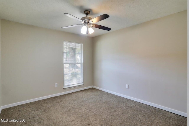 carpeted empty room with ceiling fan and a textured ceiling