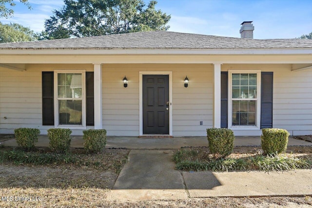 view of exterior entry with covered porch