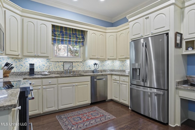150 Harper St, Ridgeland, MS 39157 - kitchen featuring appliances with stainless steel finishes, a sink, dark wood-style floors, light stone countertops, and ornamental molding