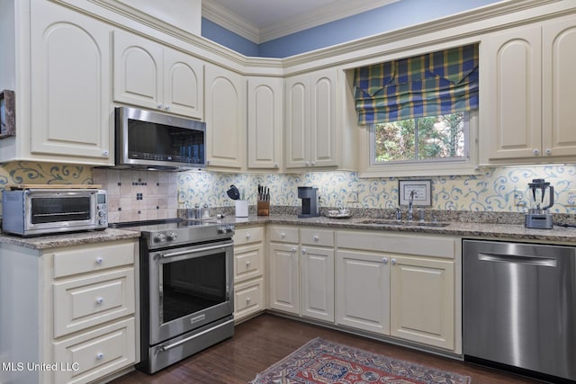 150 Harper St, Ridgeland, MS 39157 - kitchen featuring appliances with stainless steel finishes, a sink, dark wood-style flooring, light stone countertops, and backsplash