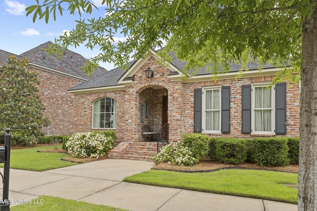 150 Harper St, Ridgeland, MS 39157 - view of front of house featuring brick siding, a front lawn, and a shingled roof