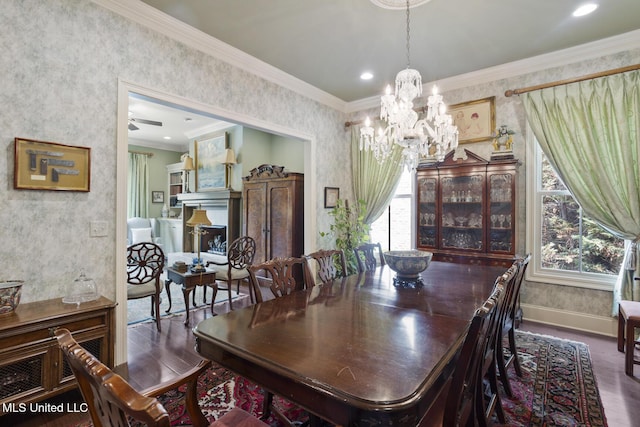 150 Harper St, Ridgeland, MS 39157 - dining area with wallpapered walls, wood finished floors, a chandelier, baseboards, and crown molding