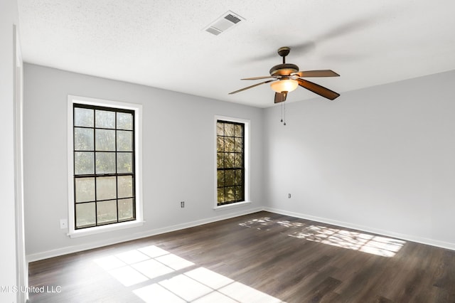 spare room featuring ceiling fan, wood-type flooring, and a textured ceiling