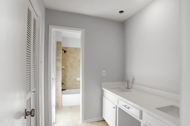 bathroom featuring tile patterned floors, vanity, and tiled shower / bath combo