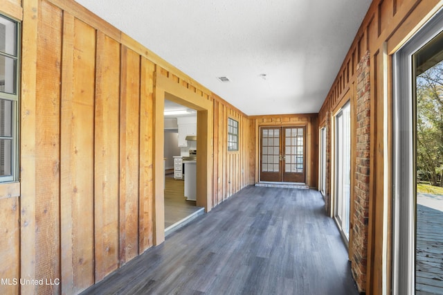 unfurnished sunroom with french doors