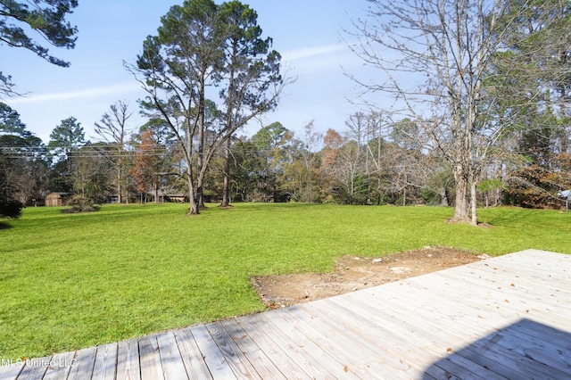 wooden terrace featuring a lawn