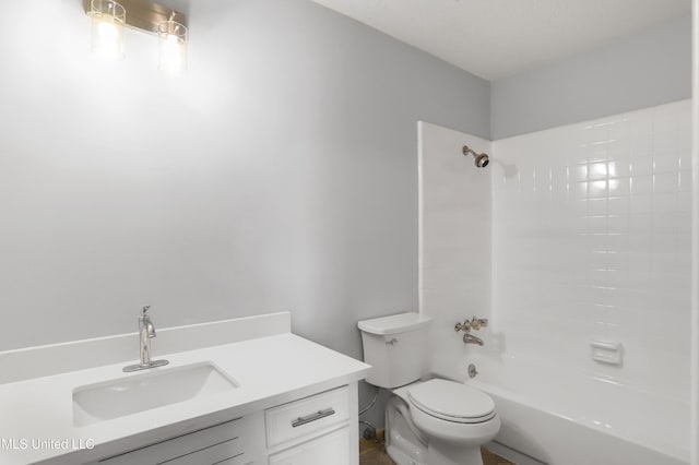 full bathroom with toilet, tiled shower / bath, and vanity